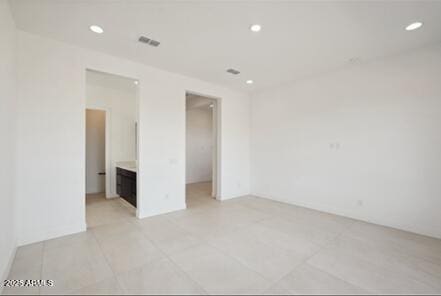 unfurnished bedroom featuring light tile patterned flooring, visible vents, and recessed lighting