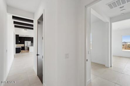 corridor with light tile patterned flooring and visible vents