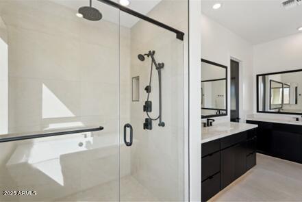 full bath with vanity, visible vents, and a stall shower