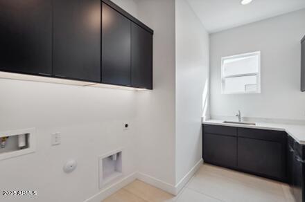 laundry area featuring electric dryer hookup, washer hookup, cabinet space, baseboards, and gas dryer hookup