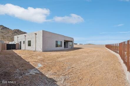 exterior space with fence and stucco siding