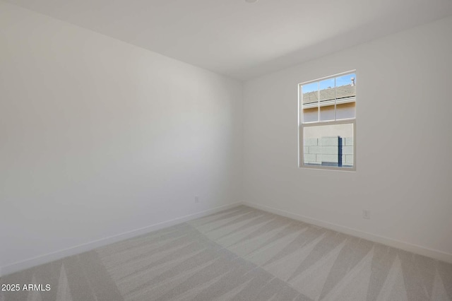 empty room featuring light carpet