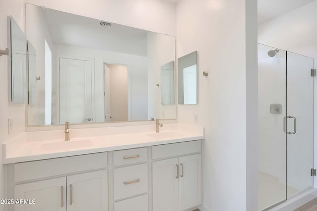 bathroom featuring vanity and an enclosed shower