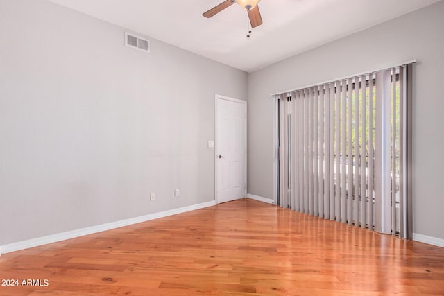 empty room with hardwood / wood-style flooring and ceiling fan