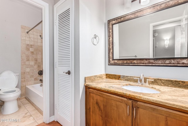 full bathroom featuring vanity, tiled shower / bath combo, and toilet