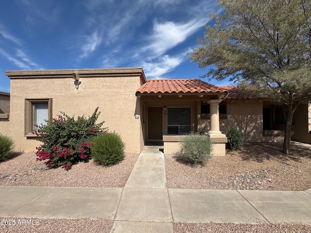 mediterranean / spanish-style home featuring stucco siding and a tiled roof