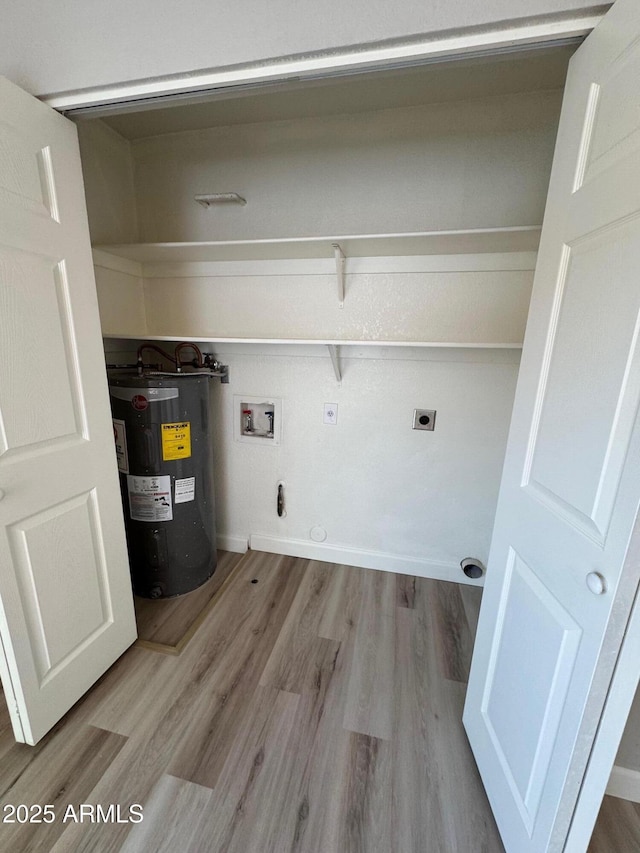 clothes washing area with laundry area, wood finished floors, electric water heater, electric dryer hookup, and washer hookup