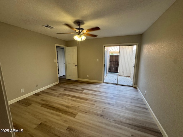 unfurnished bedroom featuring baseboards, visible vents, access to exterior, and wood finished floors