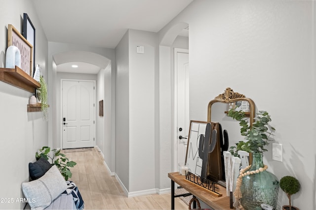 3505 W Verde River Rd, San Tan Valley, AZ 85144 - hall featuring baseboards, arched walkways, and light wood-style floors