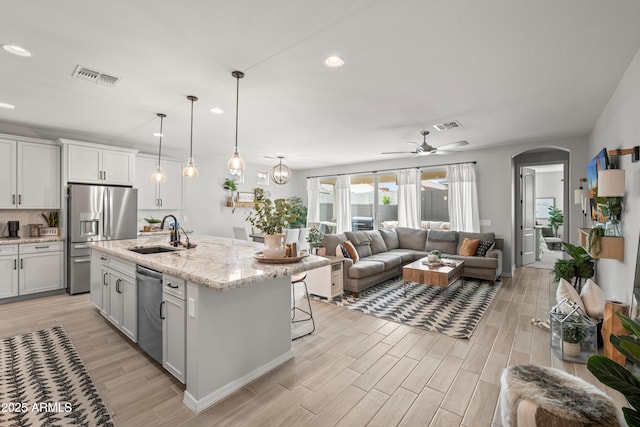 3505 W Verde River Rd, San Tan Valley, AZ 85144 - kitchen featuring stainless steel appliances, open floor plan, visible vents, and a sink