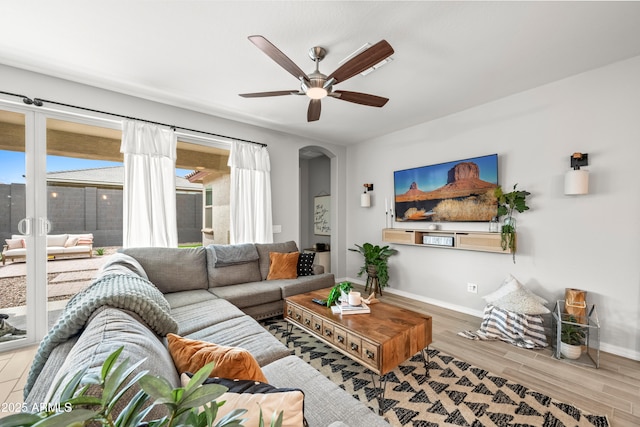 3505 W Verde River Rd, San Tan Valley, AZ 85144 - living room featuring arched walkways, baseboards, wood finished floors, and ceiling fan