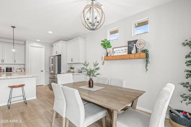 3505 W Verde River Rd, San Tan Valley, AZ 85144 - dining room featuring light wood-style flooring, a notable chandelier, baseboards, and recessed lighting