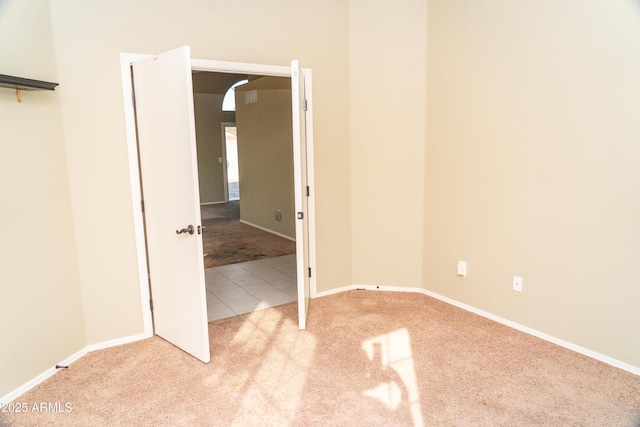 unfurnished bedroom with light colored carpet