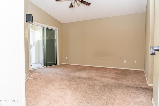 spare room featuring lofted ceiling, carpet floors, and ceiling fan