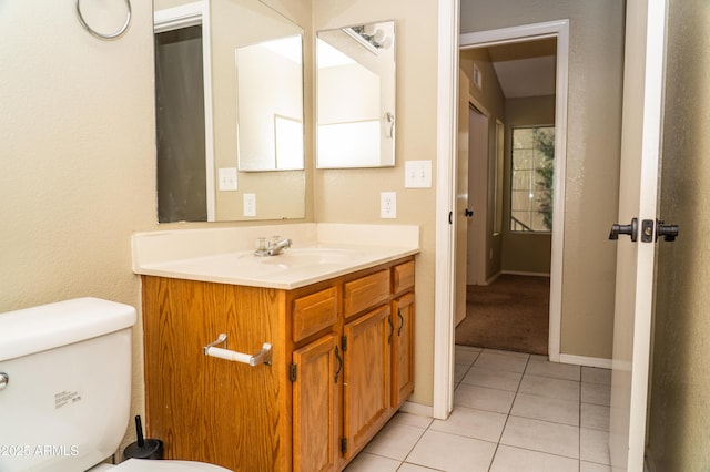 bathroom with vanity, tile patterned floors, and toilet