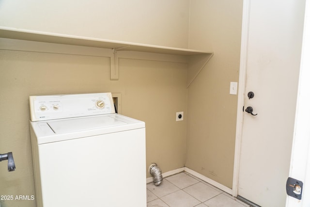 clothes washing area with washer / clothes dryer and light tile patterned floors