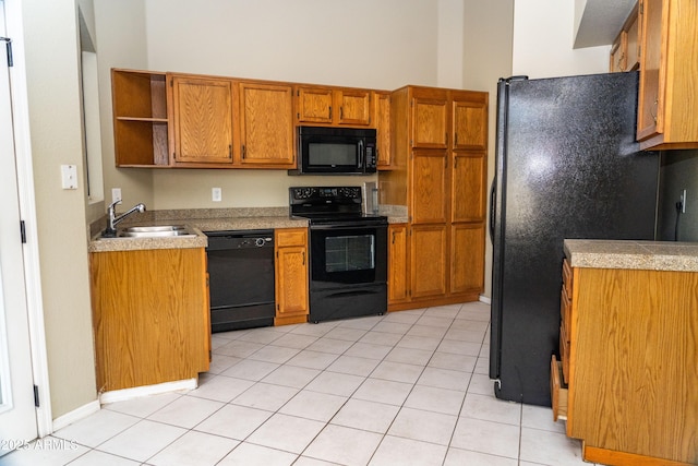 kitchen with sink, light tile patterned floors, and black appliances