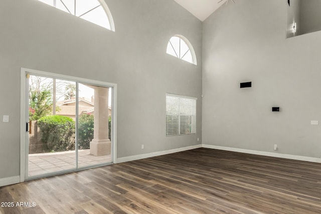 3832 N Gallatin, Mesa, AZ 85215 - unfurnished living room featuring baseboards, high vaulted ceiling, and wood finished floors