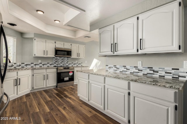 3832 N Gallatin, Mesa, AZ 85215 - kitchen featuring backsplash, white cabinets, appliances with stainless steel finishes, and dark wood-type flooring