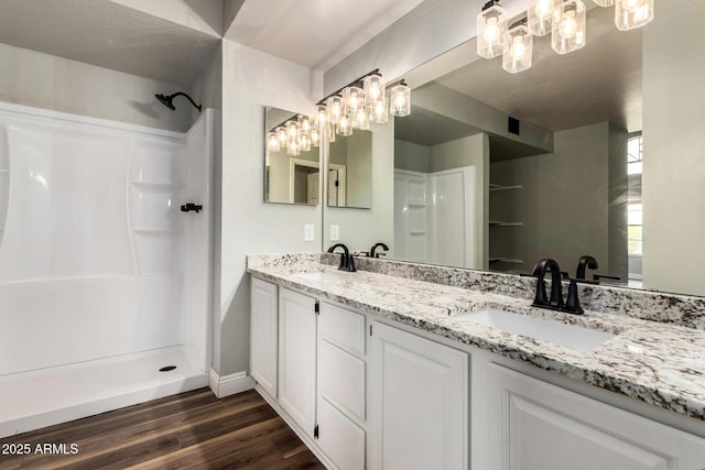 3832 N Gallatin, Mesa, AZ 85215 - bathroom featuring a sink, a shower, a notable chandelier, and wood finished floors