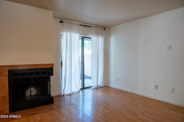 unfurnished living room featuring hardwood / wood-style flooring