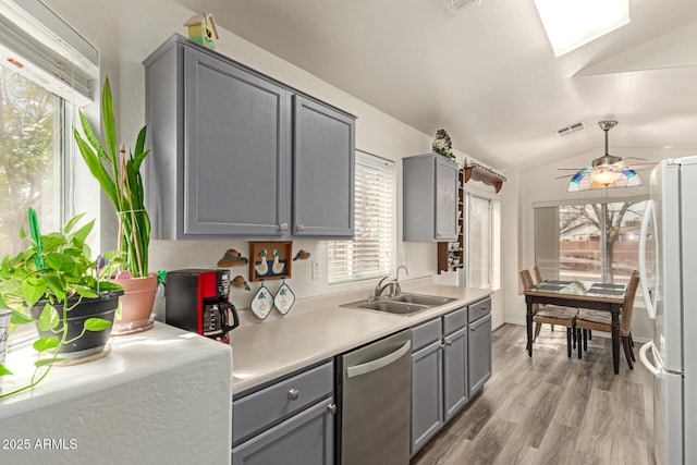 kitchen featuring dishwasher, freestanding refrigerator, and gray cabinetry