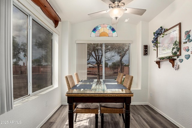 dining area with baseboards, lofted ceiling, wood finished floors, and a ceiling fan