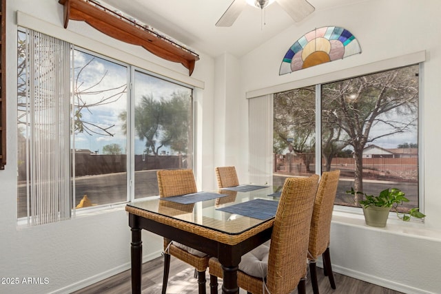 dining room with ceiling fan, baseboards, lofted ceiling, and wood finished floors