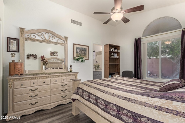 bedroom featuring ceiling fan, visible vents, ensuite bath, and dark wood-style floors