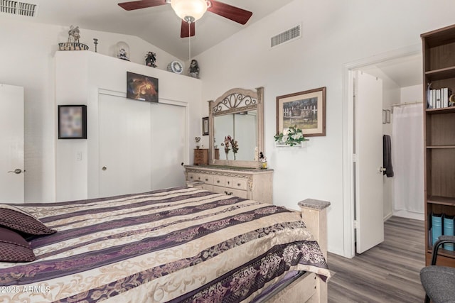 bedroom featuring lofted ceiling, visible vents, a closet, and dark wood-type flooring