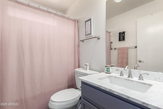 bathroom with vanity, a shower with shower curtain, and toilet