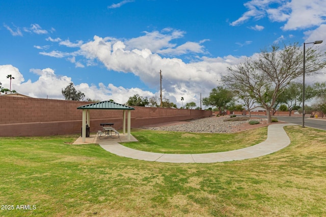 surrounding community with a gazebo, a patio area, a lawn, and fence