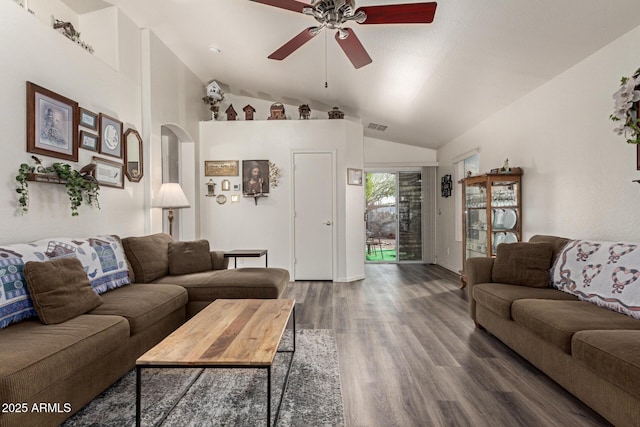 living area featuring wood finished floors, a ceiling fan, visible vents, lofted ceiling, and arched walkways