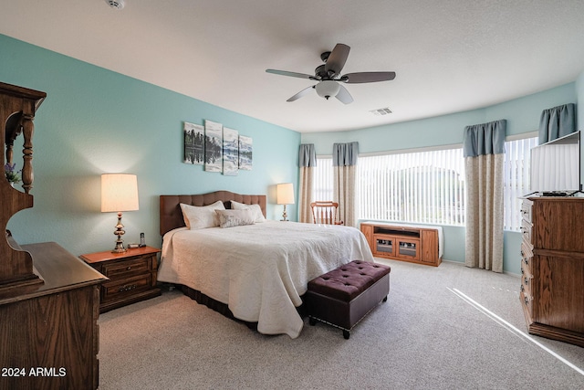 bedroom with ceiling fan and light colored carpet