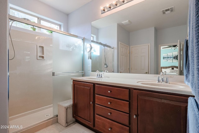 bathroom with vanity, tile patterned floors, ceiling fan, and a shower with shower door