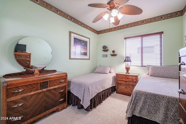 bedroom featuring light carpet and ceiling fan