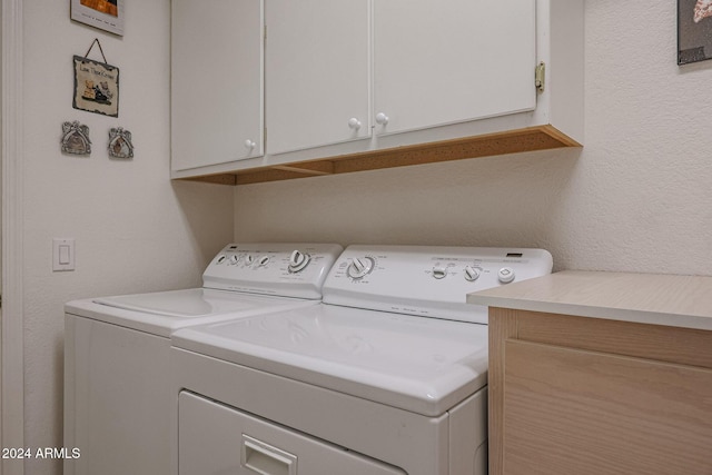 laundry area featuring cabinets and washing machine and clothes dryer