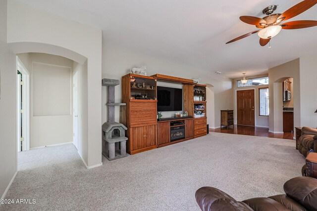 living room with ceiling fan and carpet