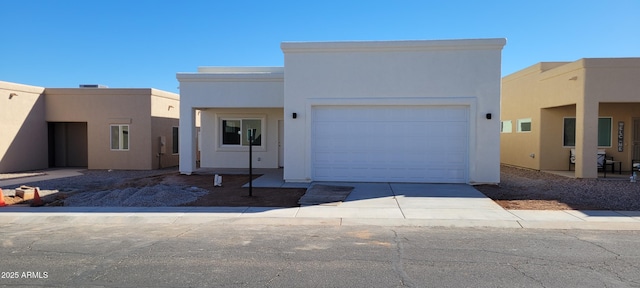 southwest-style home featuring a garage