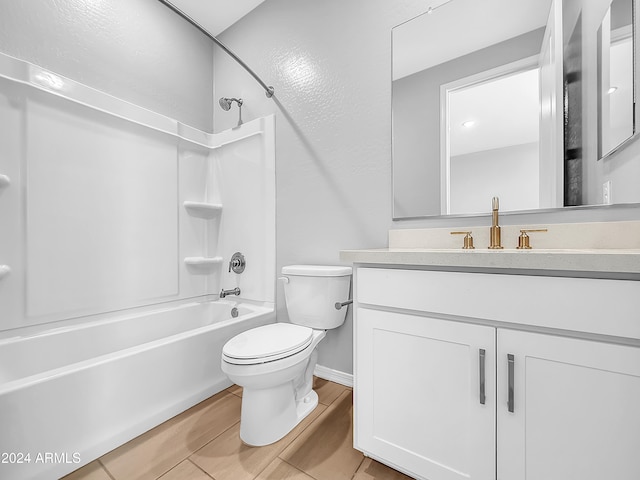 full bathroom featuring washtub / shower combination, vanity, tile patterned flooring, and toilet