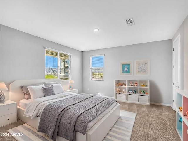 carpeted bedroom featuring multiple windows