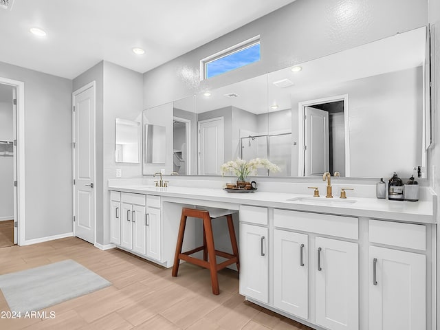 bathroom with vanity, wood-type flooring, and a shower with door