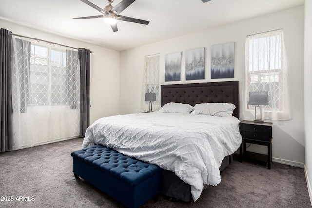 bedroom featuring ceiling fan, multiple windows, carpet flooring, and baseboards