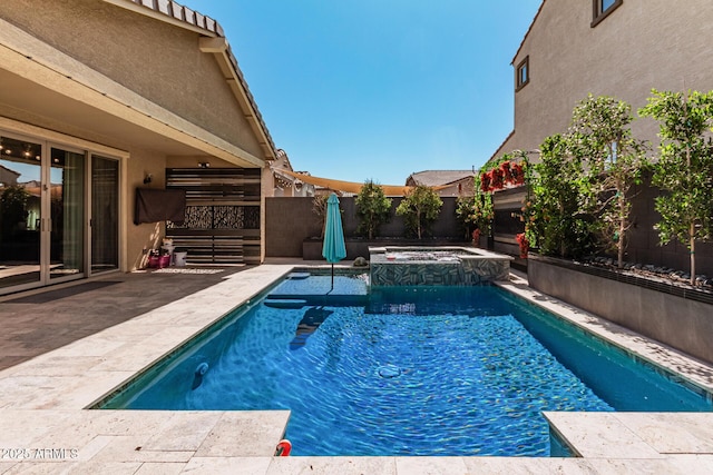 view of pool with a patio, a fenced backyard, and a pool with connected hot tub