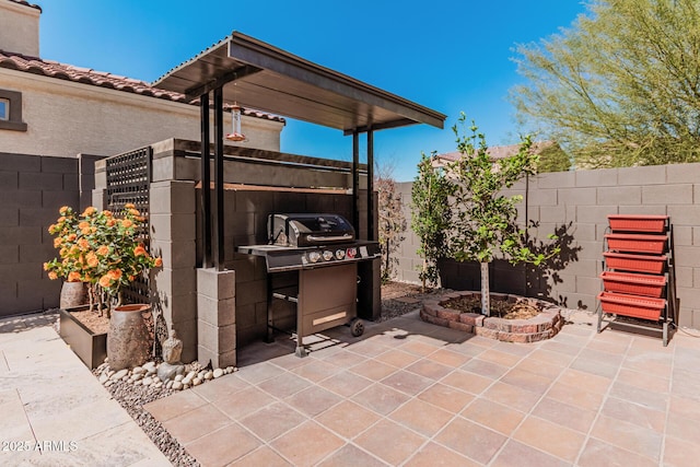 view of patio with fence and area for grilling