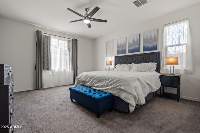 carpeted bedroom featuring a ceiling fan, visible vents, and baseboards