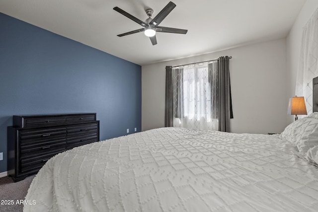 carpeted bedroom featuring ceiling fan and baseboards