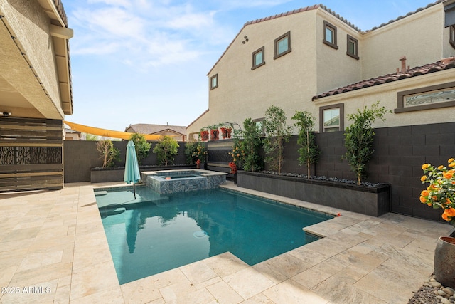 view of swimming pool with a patio, a fenced backyard, and a pool with connected hot tub