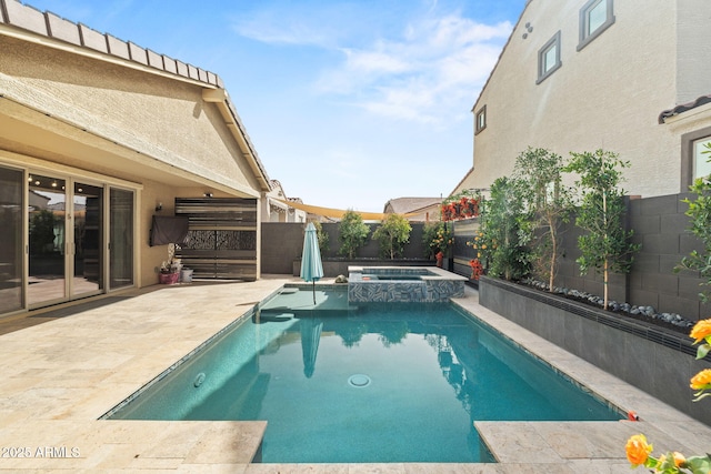 view of swimming pool featuring a pool with connected hot tub, a patio area, and a fenced backyard