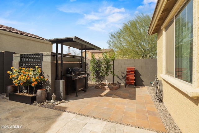 view of patio with fence and area for grilling